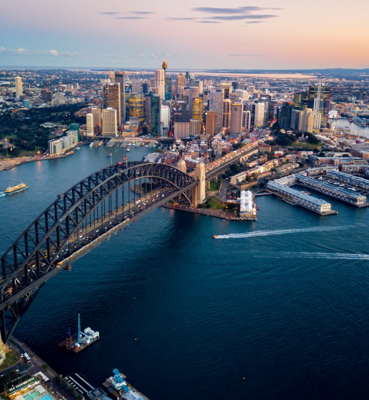 Photo of Sydney Harbour Bridge with the CBD in the background.