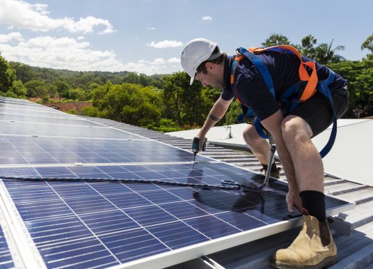 Worker installs solar panels.